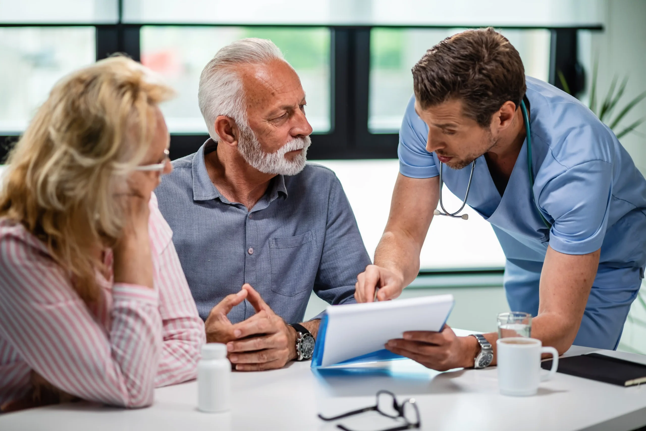 serious-doctor-discussing-with-senior-couple-about-their-medical-documents-appointment-clinic (1)