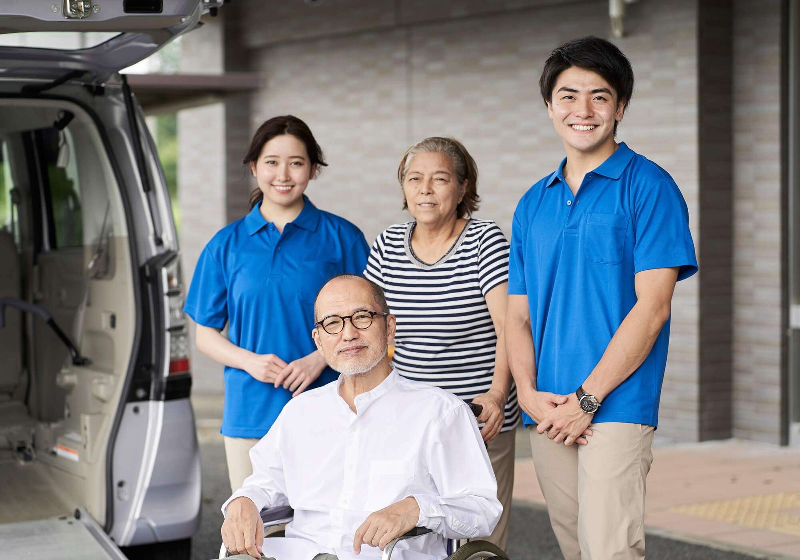 wheelchair-riding-elderly-and-caregivers-DKK2YJS.jpg